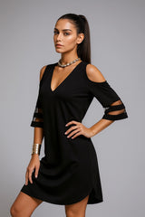 Black cold-shoulder dress with cut-out sleeves – chic women’s evening outfit